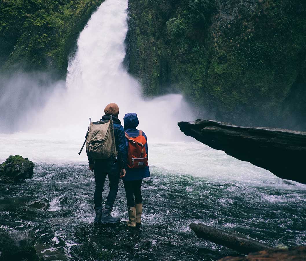 Two people staring at a waterfall